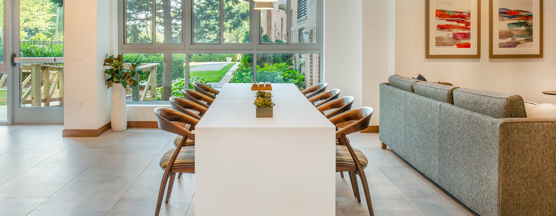 Dining room or conference table in common area of our Arlington apartment. White table with gold chairs.